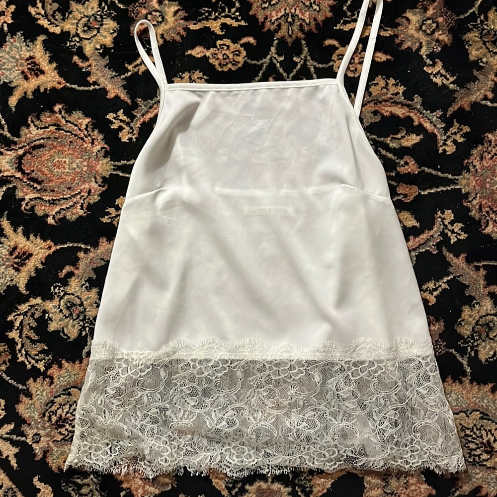 The hanger. Size medium/small. White tank with lace.